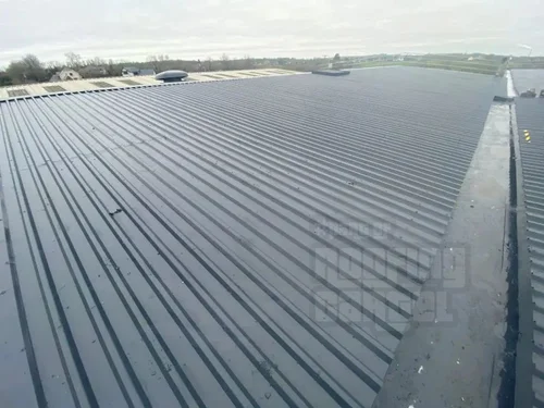 Professional metal roof waterproofing treatment in progress