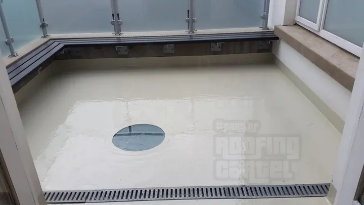 Professionally waterproofed balcony with glass railing and drainage system