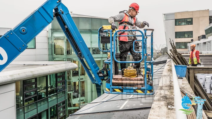 Commercial roof waterproofing system being applied on large industrial building
