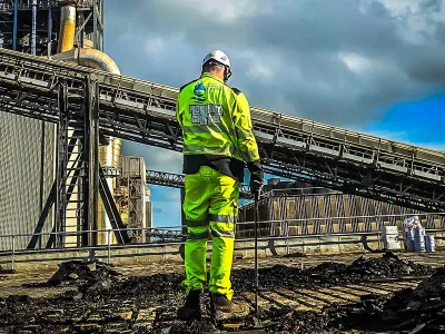 Roof inspector assessing industrial facility roof for waterproofing in Ireland