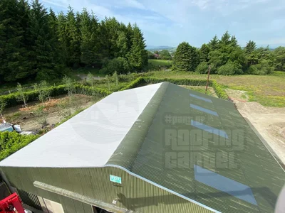 Metal roof partially waterproofed showing before and after difference