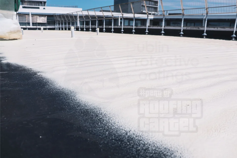 Professional polyurea coating being applied to a flat roof surface